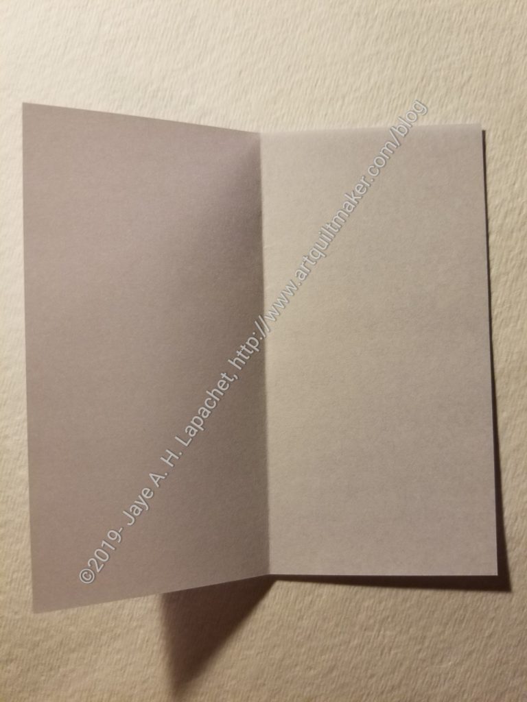 Fold the paper in half