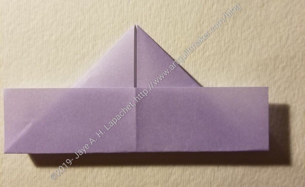 Fold the bottom back on to the triangles