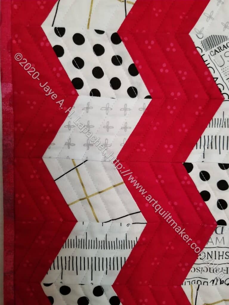 Red Text Table Runner quilting detail