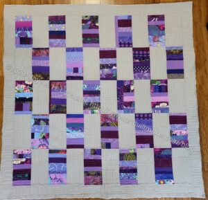 Purple Strip donation quilt quilted