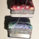 Side view of Altoids tin Sewing Kit