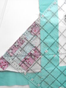 Fold quilt in half diagonally
