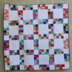 Sidewalk donation quilt quilted and bound